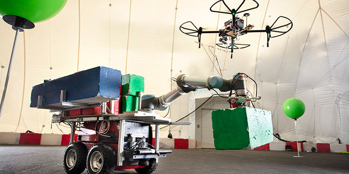 Moving robot with coloured ‘building blocks’ and drone. (Photo: Mikal Schlosser)
